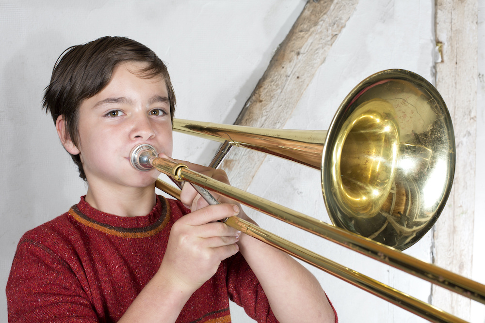 boy with a trombone Learn how you can play an instrument with braces in Mount Pleasant SC