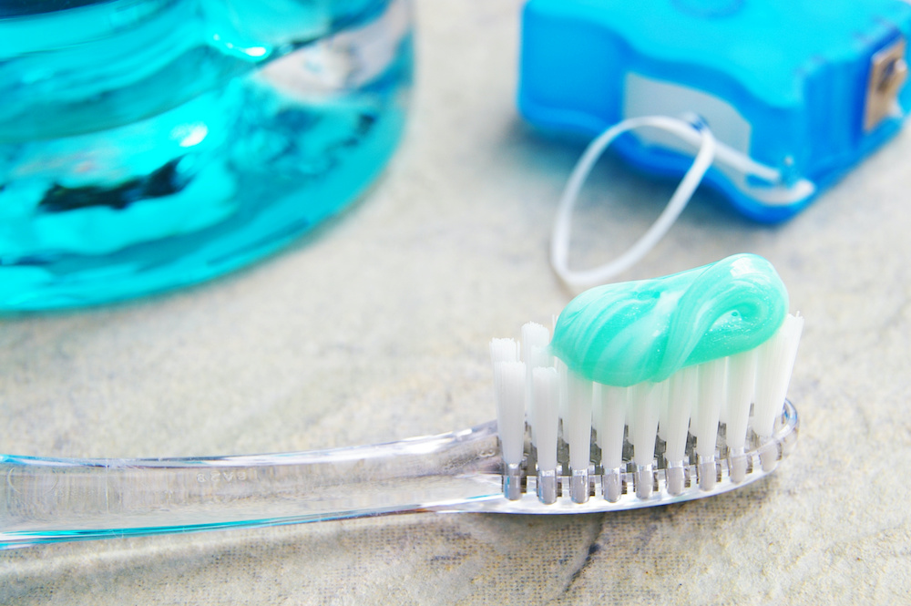 Closeup of a tooth brush, with floss and rinse Learn how to take care of your teeth and braces from an orthodontist in Mount Pleasant