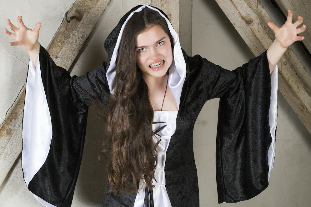 young woman dressed as a witch young woman dressed as a witch with braces