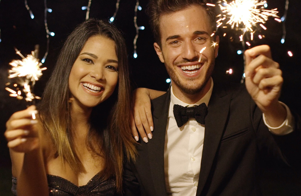 Happy young couple welcoming in the New Year Celebrate the new year with braces or Invisalign in Charleston SC