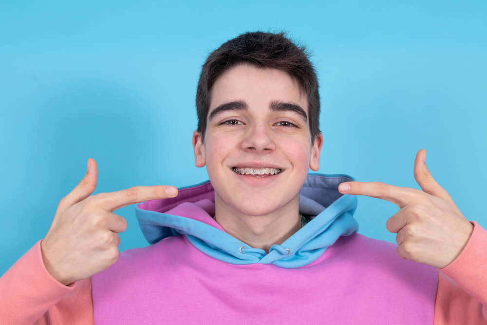 portrait of young teenage girl isolated showing braces and orthodontics Our Charleston orthodontist talks about what your teeth can tell you about your health