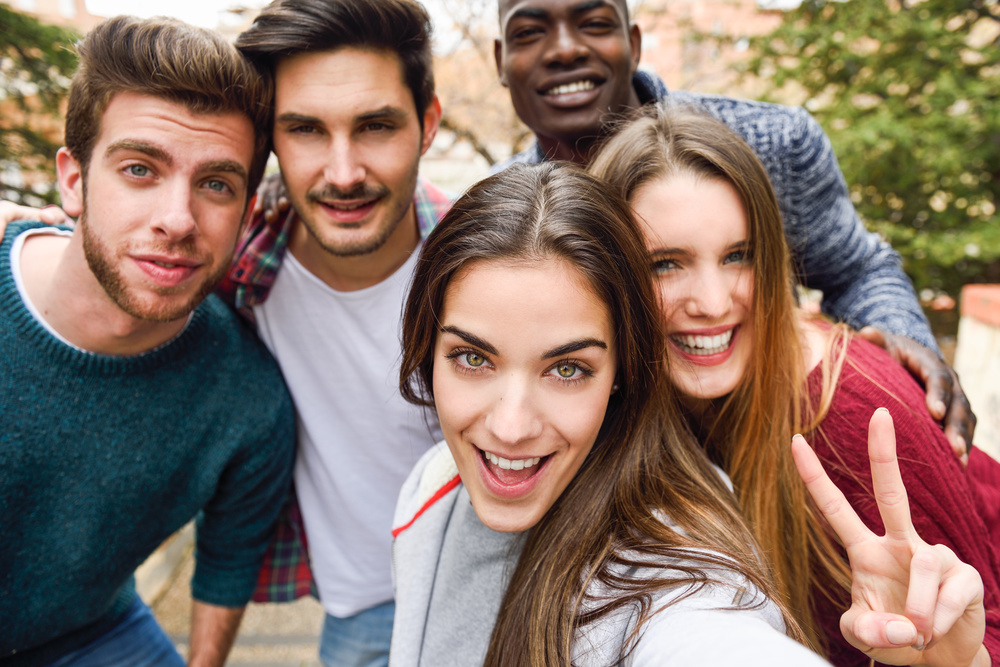 Group of friends having fun together outdoors smiling people