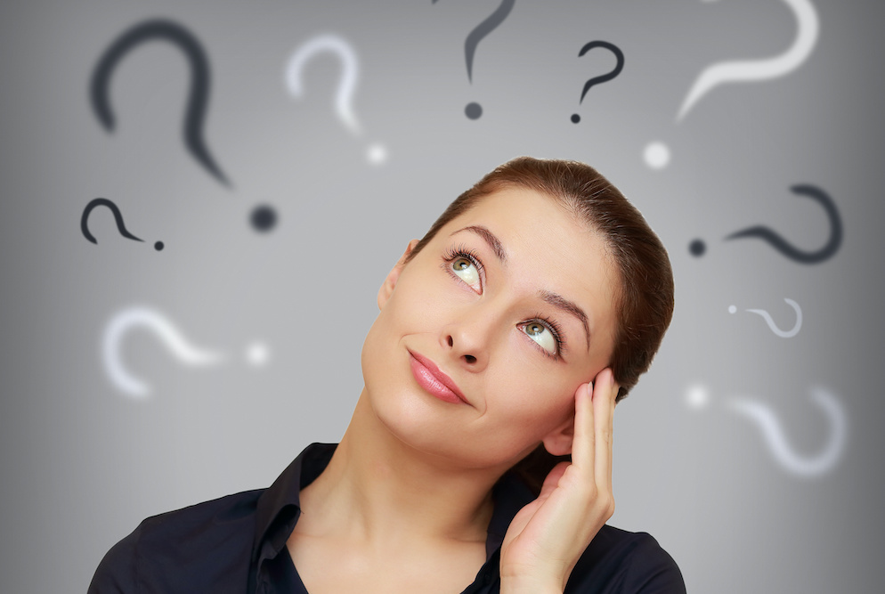 Beautiful business woman with question mark above the head looking up Can teeth get crooked again after braces?