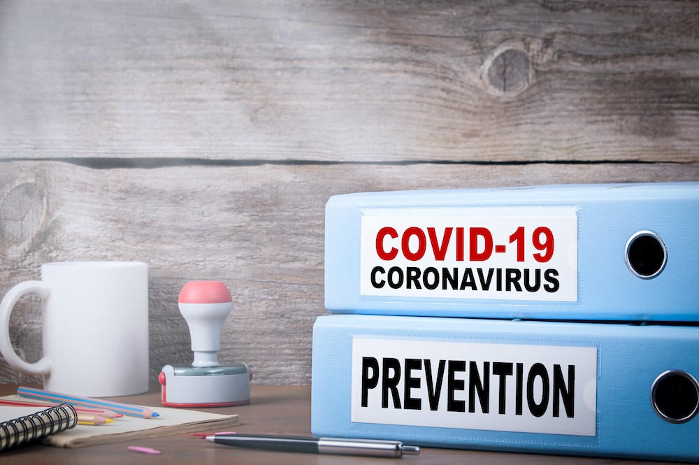COVID-19, CORONAVIRUS and PREVENTION. Two binders on desk Charleston orthodontist is keeping patients safe from Coronavirus