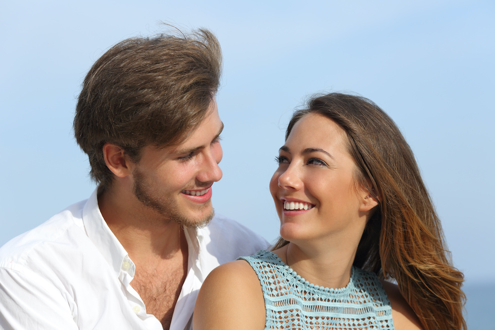 Happy couple in love looking each other gum contouring after braces in Mt Pleasant SC